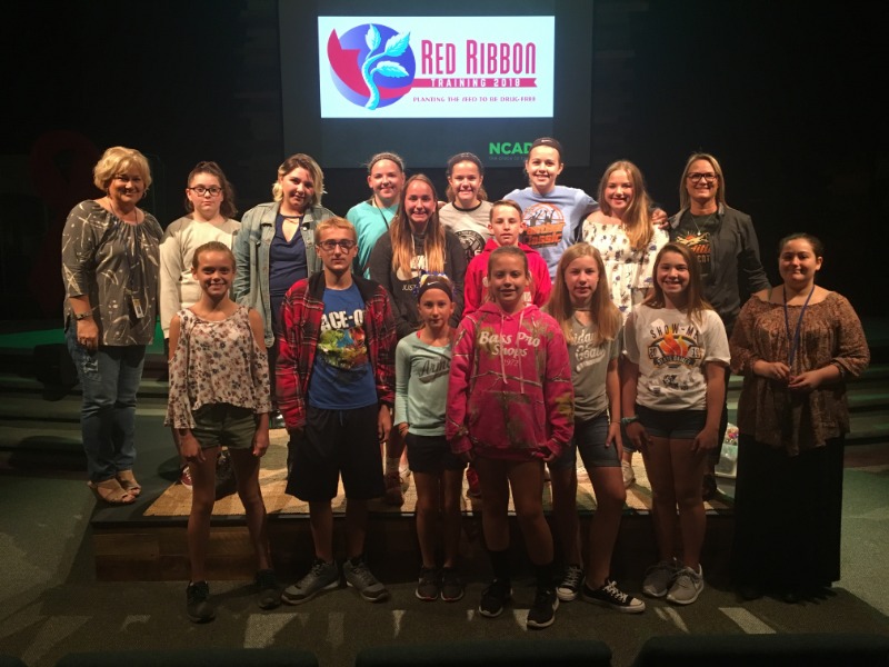 Trend Leaders with Mrs. Taylor and Mrs. Tiger in front of Red Ribbon Banner