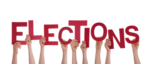 Hands holding up red letters to spell elections