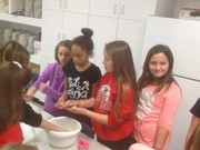 students enjoying making pizza