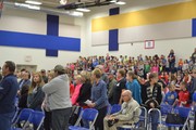 Crowd standing for vets.