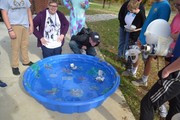 Students racing handmade boats in pool