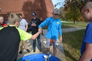 Students racing handmade boats in pool