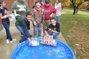 Students racing handmade boats in pool