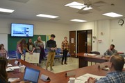 students with posters in front of board
